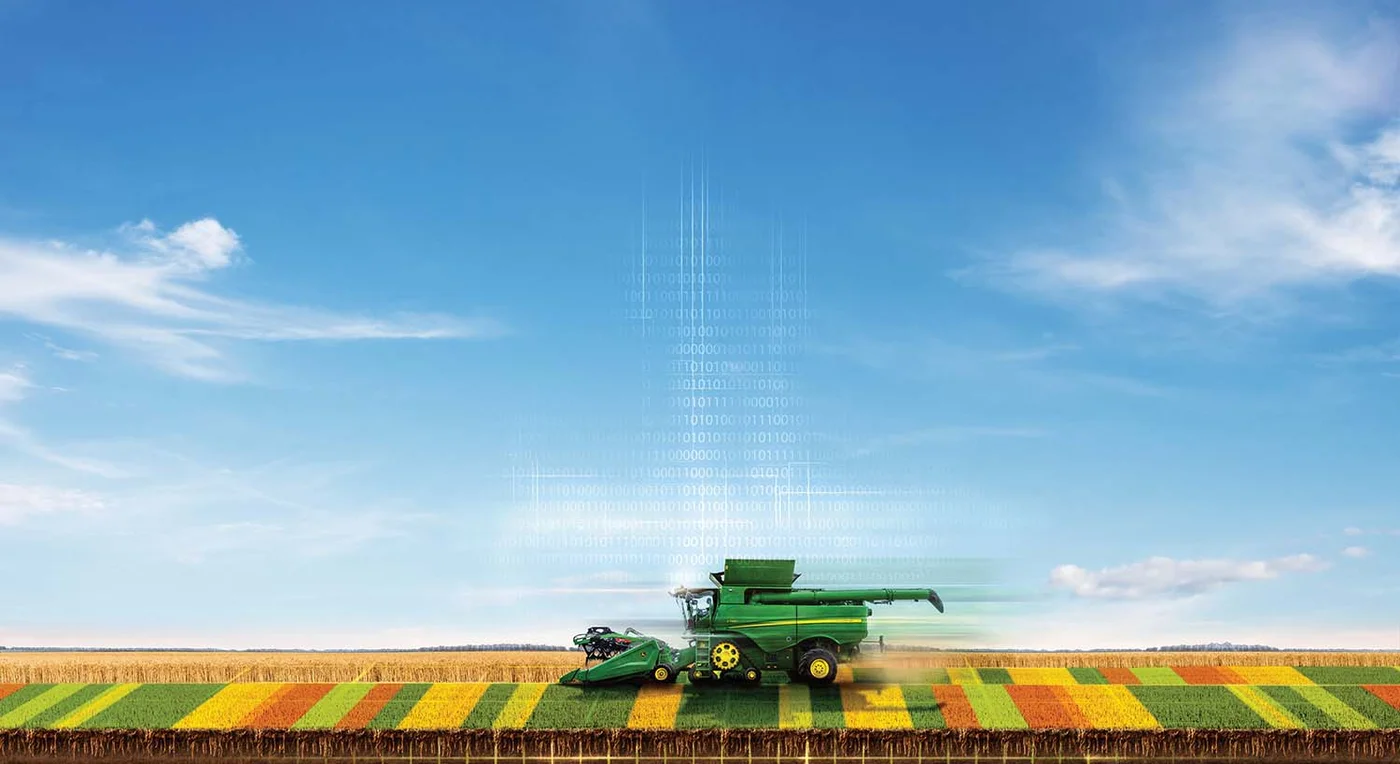 A connected John Deere Combine driving over a virtual field showing a yield map